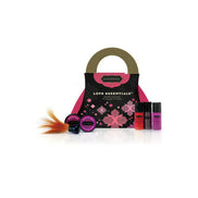 Kama Sutra Love Essentials romantic travel purse with pink and black design, containing various personal care products.