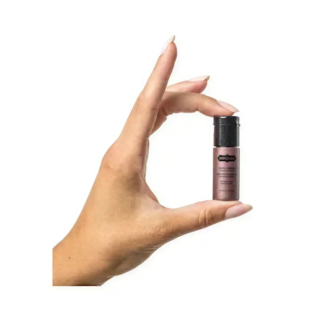 Kama Sutra Love Essentials romantic travel purse held in a hand, showcasing its compact size and sleek design.