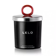 Lelo black pepper and pomegranate massage candle in a black container with a silver lid and red handle.