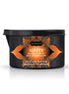 Kama Sutra Tropical Mango massage candle in a black container with orange accents, labeled "Ignite," 170g.