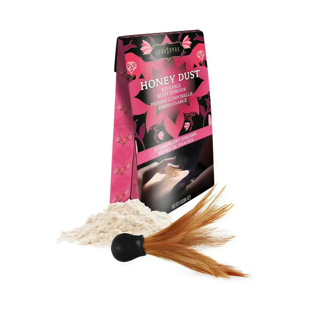 Kama Sutra Honey Dust kissable body powder in Strawberry Dreams, with a feather applicator and powder spilling from the box.