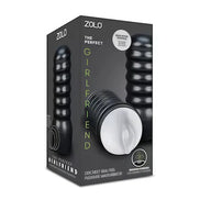 Zolo male masturbator in a hard shell packaging, featuring a textured black exterior and a white interior.