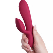 Rocks Off Every Girl vibrator in a deep pink color, held in a hand, featuring a curved design and textured surface in a hand.