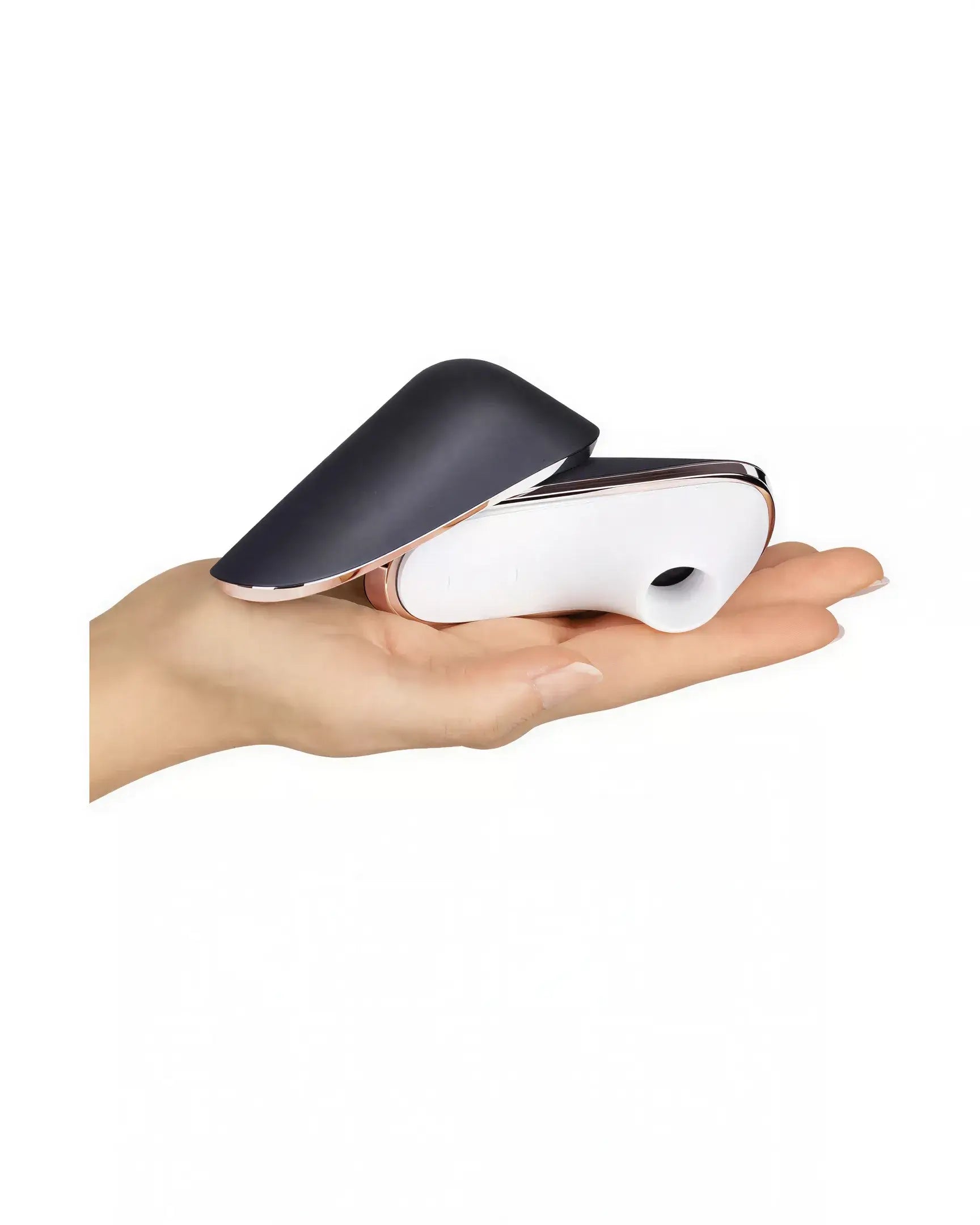 Satisfyer Pro Traveler in a hand, featuring a sleek black and white design with a curved shape for portability.