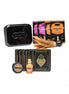 Kama Sutra Weekender Kit in Tropical Mango with massage oil, lubricants, and a feather applicator in a black tin.