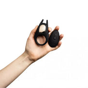 Share Satisfaction Dash II remote control vibrating cock ring held in a hand, featuring a sleek black design and ergonomic...