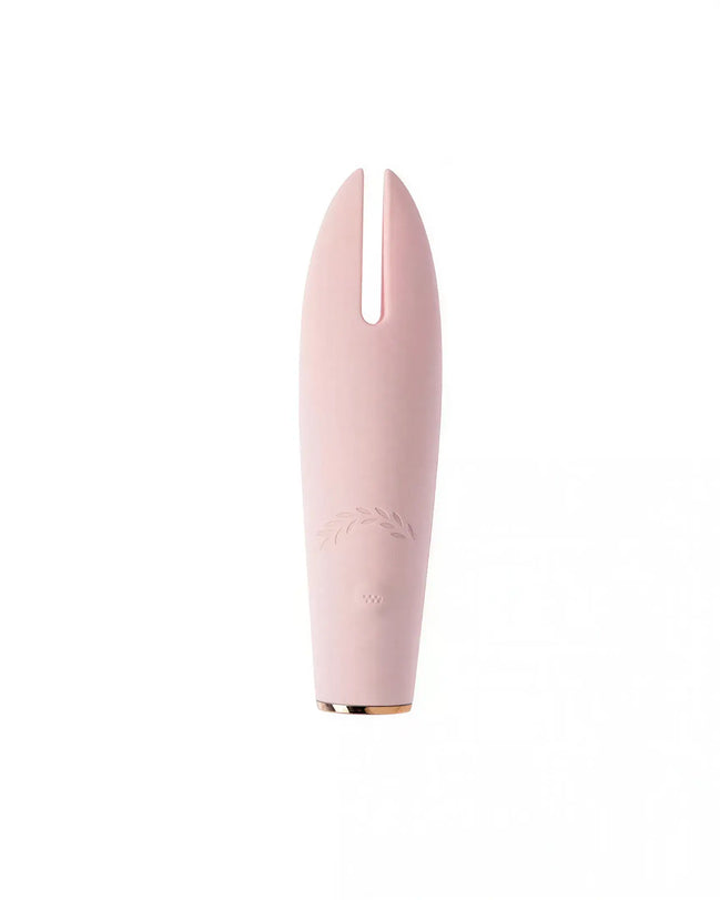 Luxury clit vibrator in soft pink color with a sleek design and a split tip for targeted stimulation.