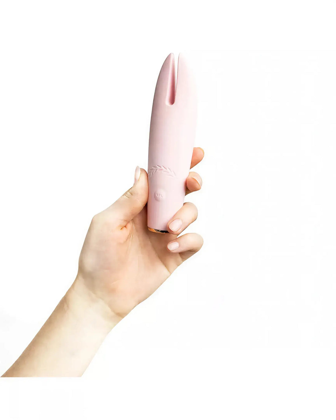 Luxury clit vibrator in soft pink, held in a hand, featuring a sleek design with a tapered tip.