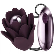 Rocks Off Zinnia vibrator in dark purple, shaped like a flower with a smooth, rounded core and control button.