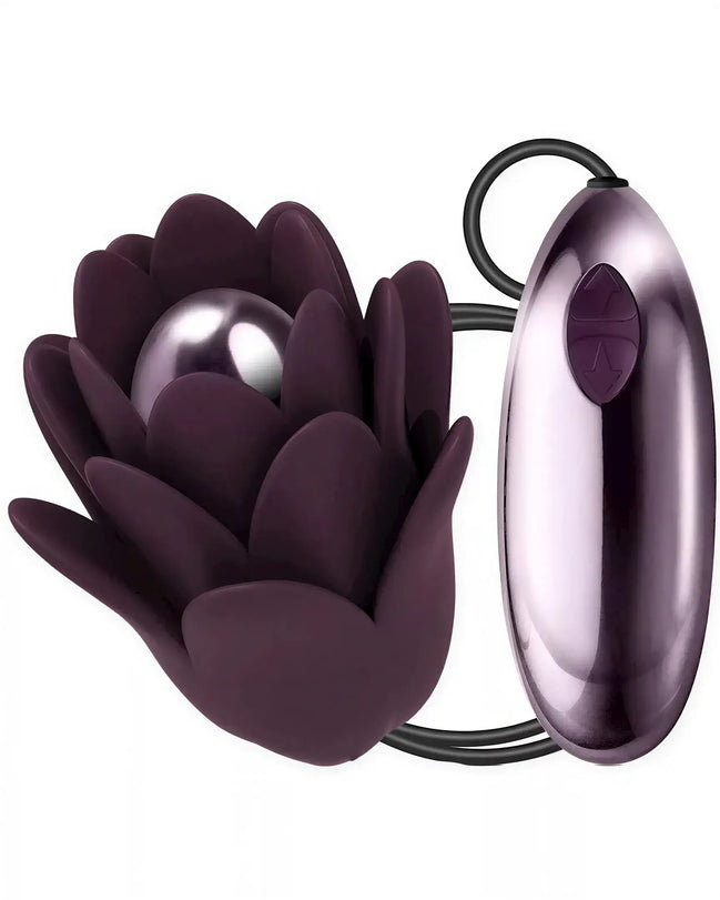 Rocks Off Zinnia vibrator in dark purple, shaped like a flower with a smooth, rounded core and control button.
