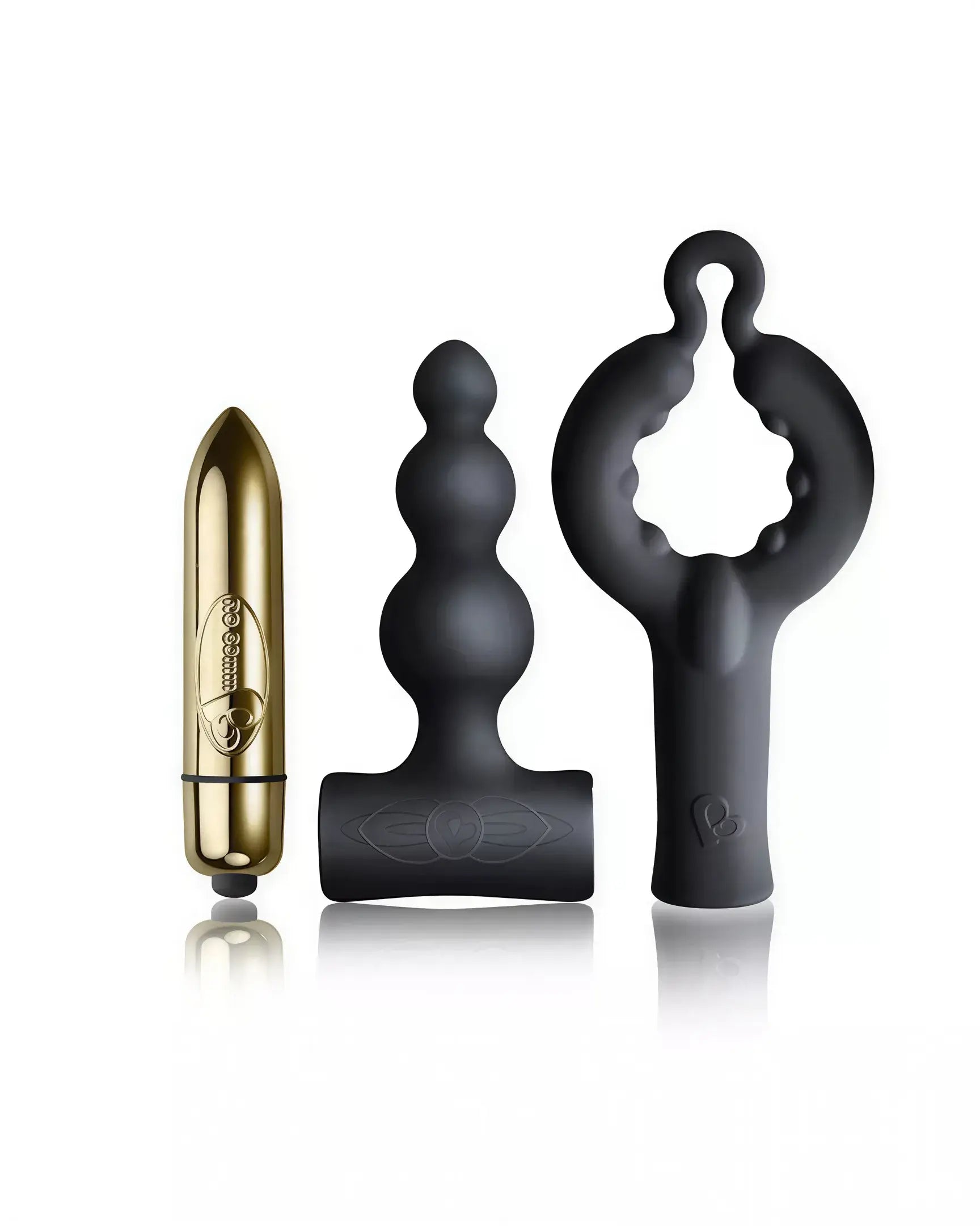 Rocks Off Silhouette Dark Desires Be Mine Kit featuring a gold bullet vibrator, black silicone anal plug, and a textured r...