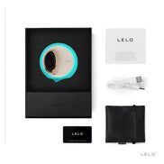 Lelo Ora 3 vibrator in a black box with turquoise accents, USB charging cable, and user guide.