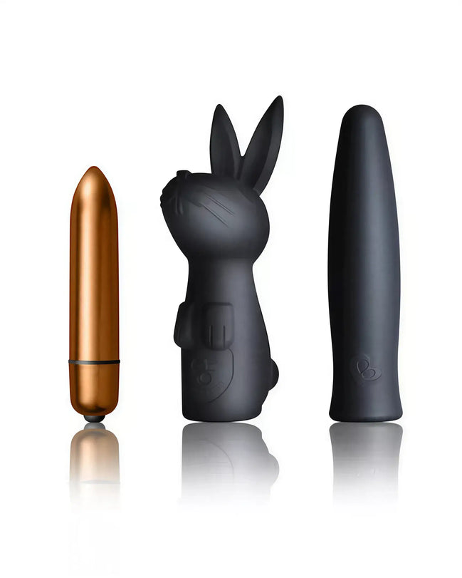 Rocks Off Silhouette Dark Desires Kit featuring a gold bullet vibrator, black bunny-shaped vibrator, and sleek black massa...