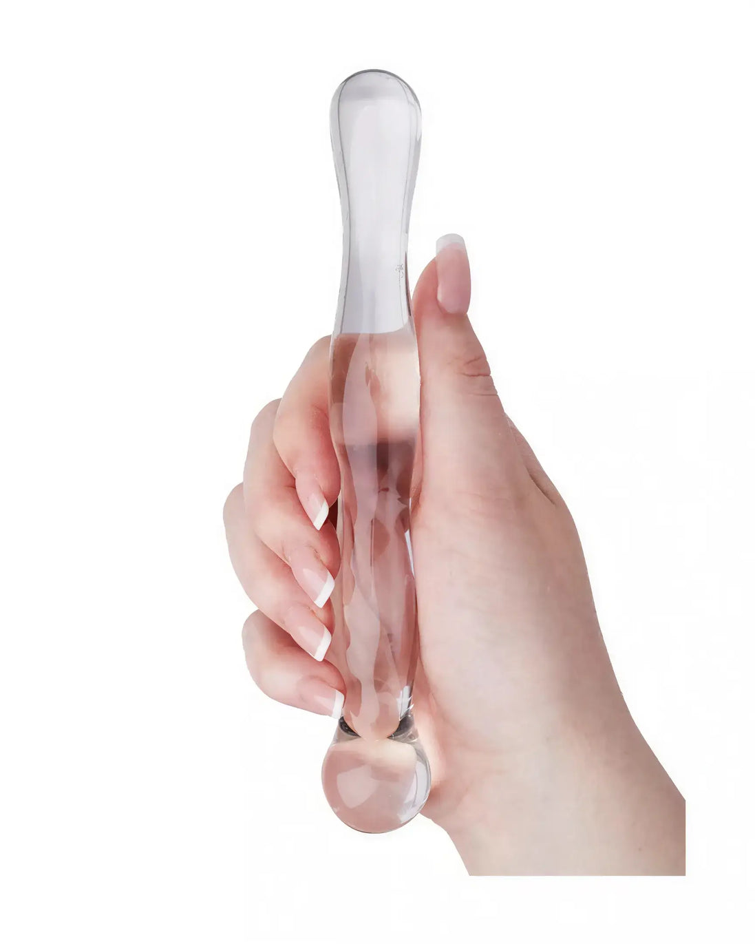Clear glass massager held in a hand, featuring a smooth, elongated design with rounded ends.