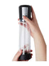 Clear penis pump with a black base, held in one hand, featuring measurement markings and a control panel on top.