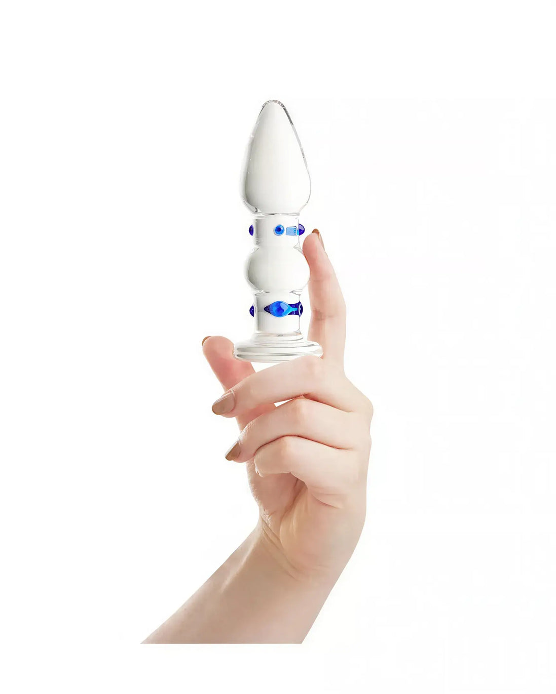 Lucent Duo glass butt plug held in a hand, featuring a white and blue design with a tapered tip and bulbous body.
