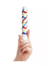 Lucent Trinity textured glass massager held in a hand, featuring a spiral design with red, blue, and yellow accents.