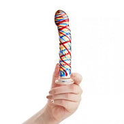 Lucent tartan glass massager held in a hand, featuring colorful swirls of red, blue, and yellow on a clear base.