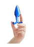 Lucent fleur glass butt plug held in a hand, featuring a smooth blue surface and tapered design.