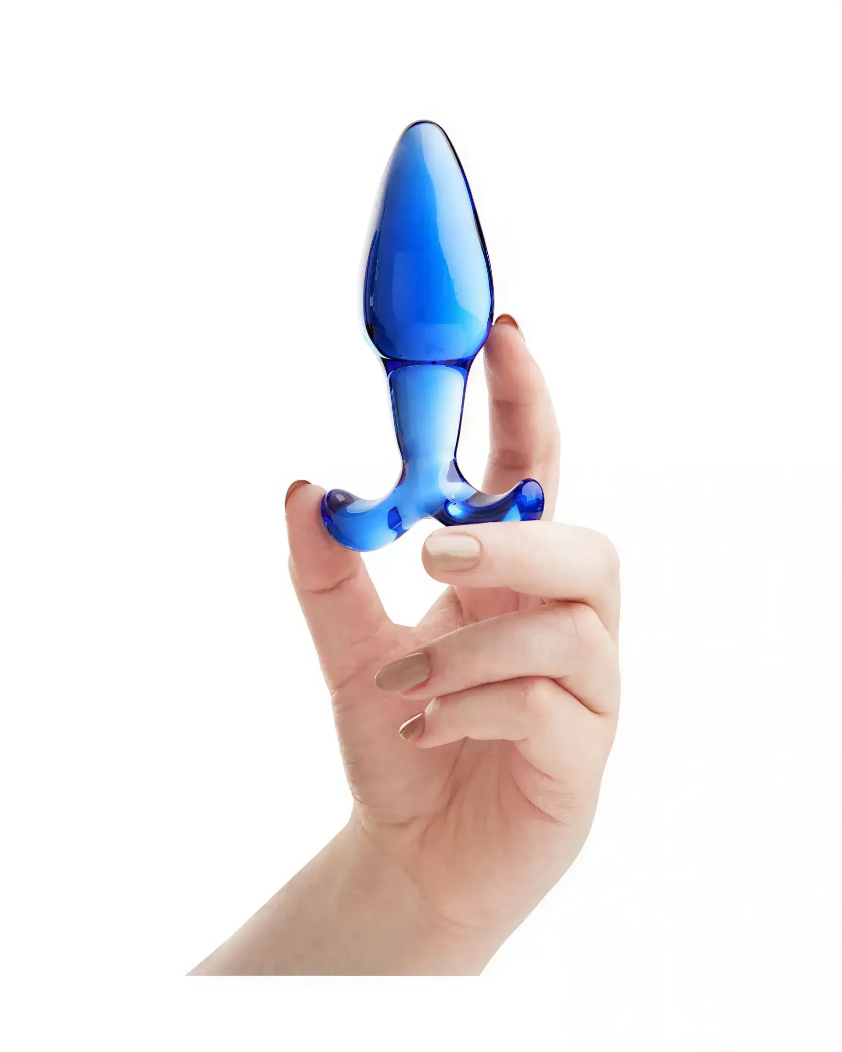 Lucent fleur glass butt plug held in a hand, featuring a smooth blue surface and tapered design.