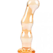 Lucent Soleil glass massager in a smooth, curved design with a translucent orange finish and a sturdy base.
