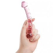 Lucent whirls glass massager held in a hand, featuring a pink gradient and textured surface for enhanced grip.