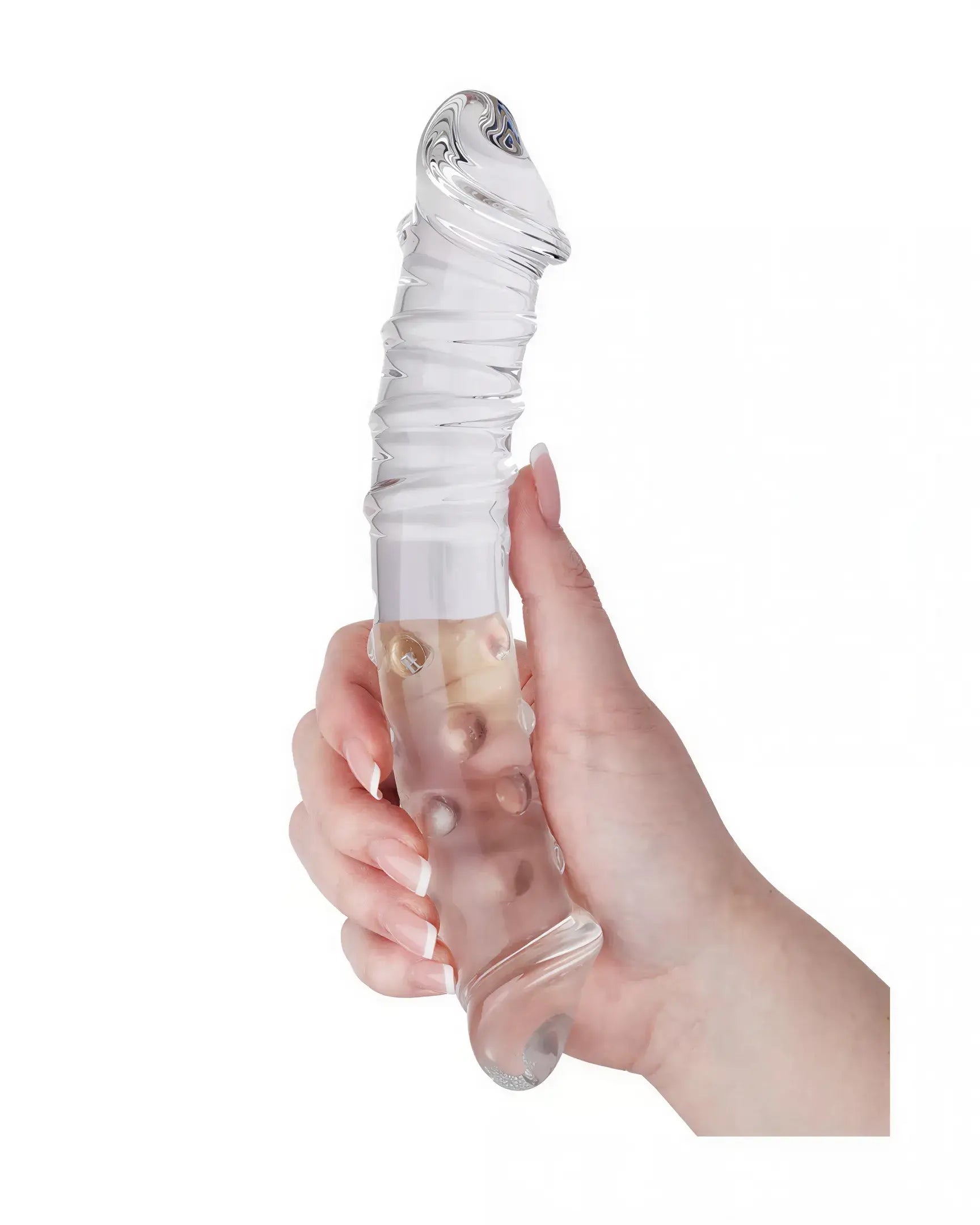 Clear glass massager with a textured body and swirling design, held in a hand for scale.