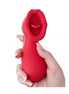 Chakra luxury tongue vibrator in red, held in a hand, featuring a textured tip for stimulation.