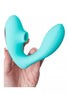 Share Satisfaction Kama in teal silicone, featuring a curved design and textured grip, held in a hand.