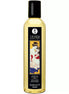 Shunga Serenity Monoi massage oil in a clear bottle with a decorative label featuring a couple.