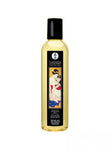 Shunga Massage Oil Island Blossoms in a clear bottle with a black cap and decorative label featuring a couple.