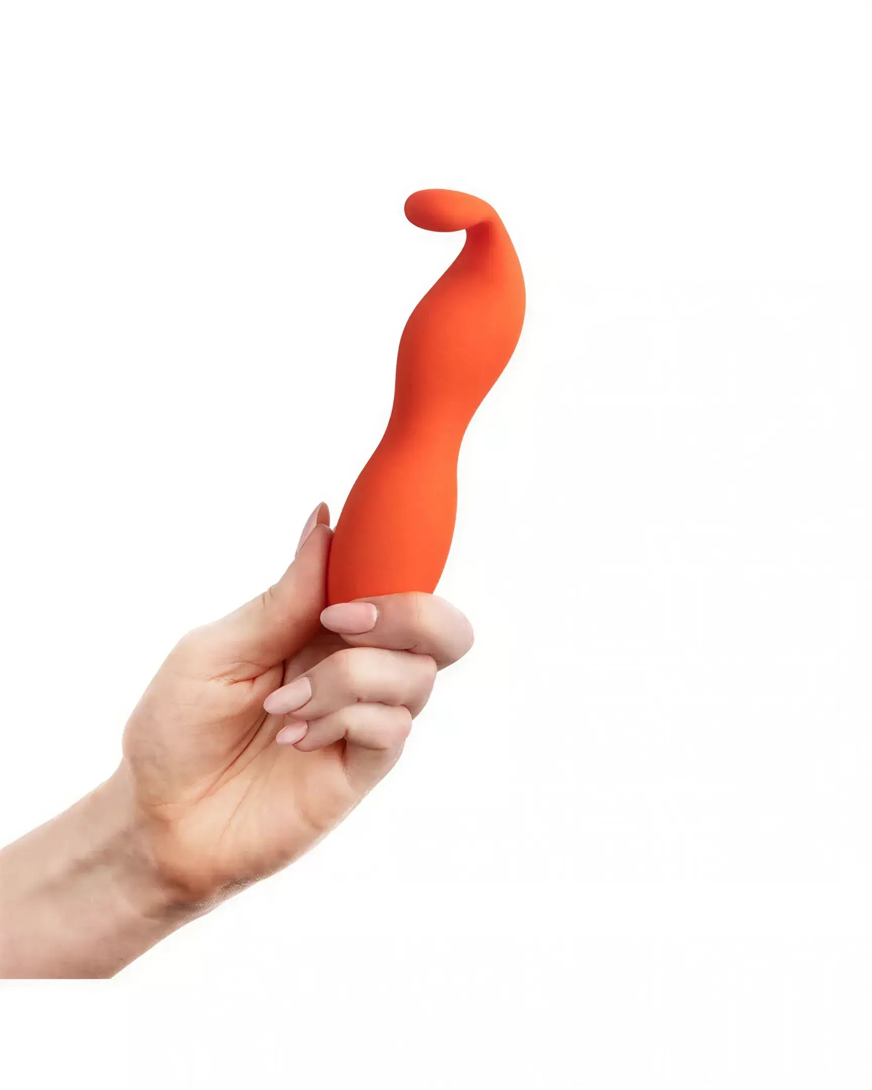 Ceba clitoral vibrator in bright orange, held in a hand, featuring a curved design for ergonomic use.