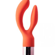 Joy dual stimulator in bright orange silicone with a metallic base, featuring two curved arms for targeted stimulation.