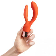 Share Satisfaction Joy dual stimulator in orange silicone held by a hand, featuring a metallic base.