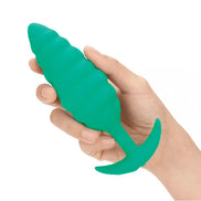B-Vibe Twist Texture Plug in green, held in a hand, featuring a textured design and tapered shape.