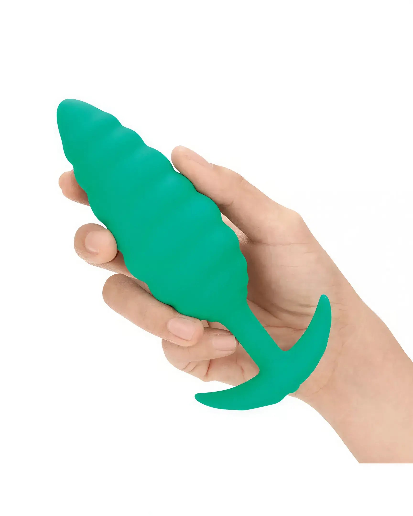 B-Vibe Twist Texture Plug in green, held in a hand, featuring a textured design and tapered shape.
