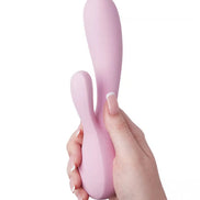 Satisfyer Mono Flex rabbit vibrator in soft pink, held in a hand, showcasing its ergonomic design and flexible shape.