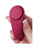 Satisfyer Sexy Secret in deep red, held in a hand, featuring a smooth silicone surface and a rounded design.