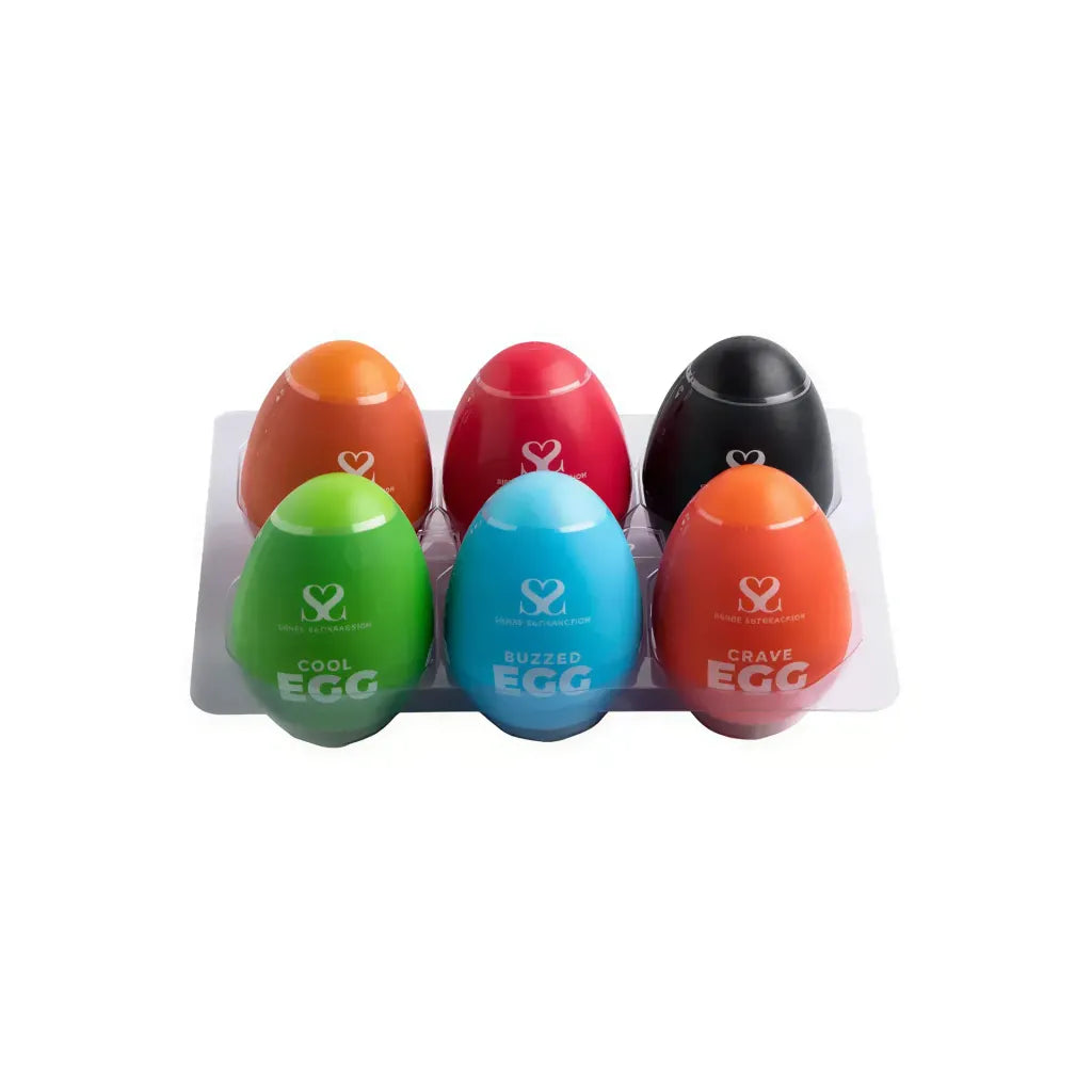 Set of six colorful masturbator eggs in a tray, featuring green, blue, orange, red, black, and purple designs.