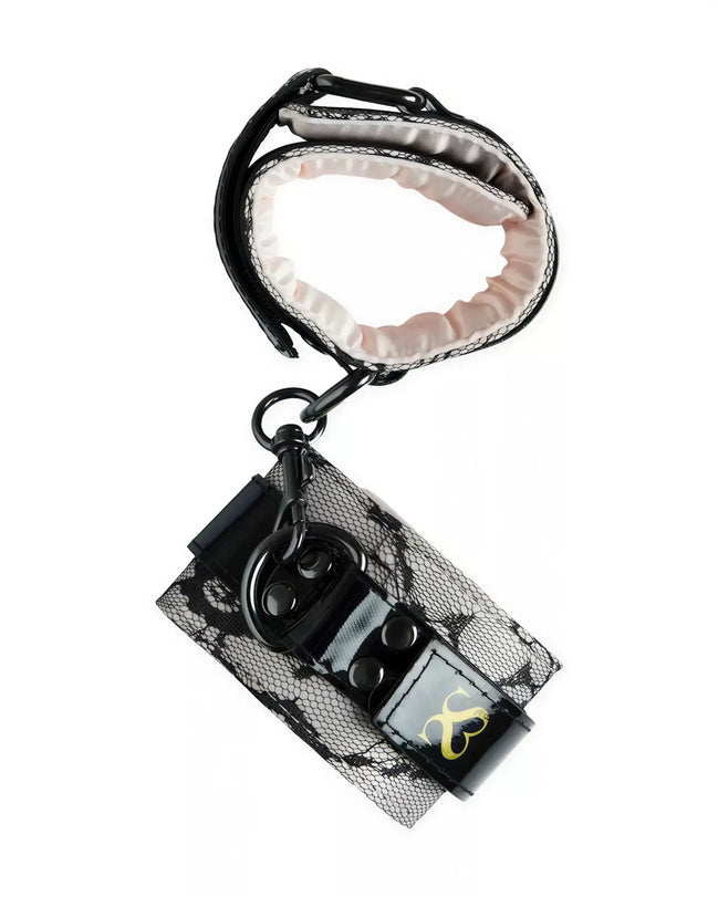 Luxury handcuffs with black lace design and pink satin lining, featuring a secure clasp and adjustable strap.