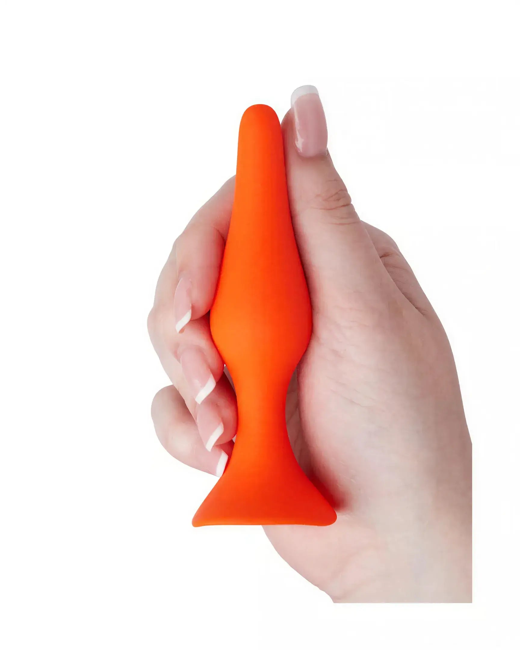 Medium silicone butt plug in bright orange, held in a hand, featuring a tapered tip and flared base for safety.