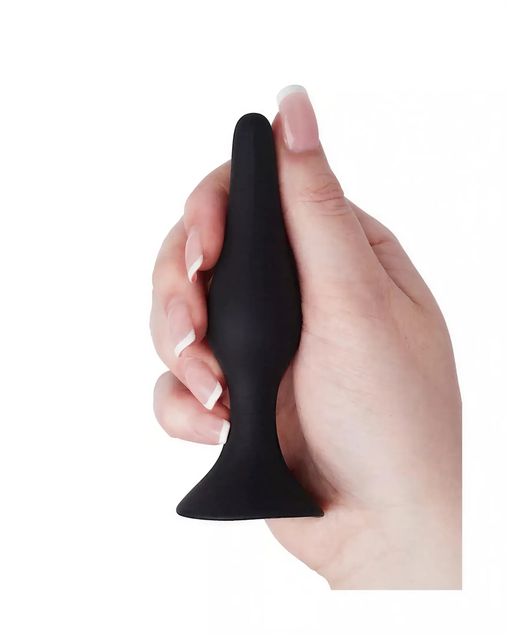 Medium silicone butt plug held in a hand, featuring a smooth black surface and tapered design for easy insertion.