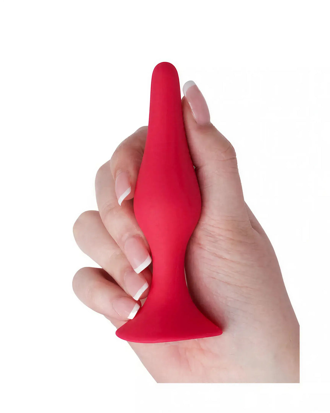 Medium silicone butt plug in red, held in a hand, featuring a tapered tip and flared base for safety.