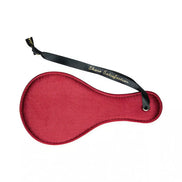 Luxury paddle in deep red with a black ribbon handle, featuring the text 