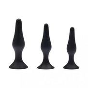 Share Satisfaction black plug kit featuring three varying sizes with smooth, tapered designs and flared bases.