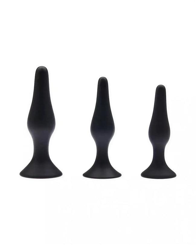 Share Satisfaction black plug kit featuring three varying sizes with smooth, tapered designs and flared bases.