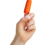 Orange Share Satisfaction finger vibe held between fingers, showcasing its textured surface and compact design.