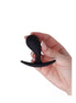 Medium curved plug held in a hand, featuring a smooth black silicone surface and a flared base for safety.