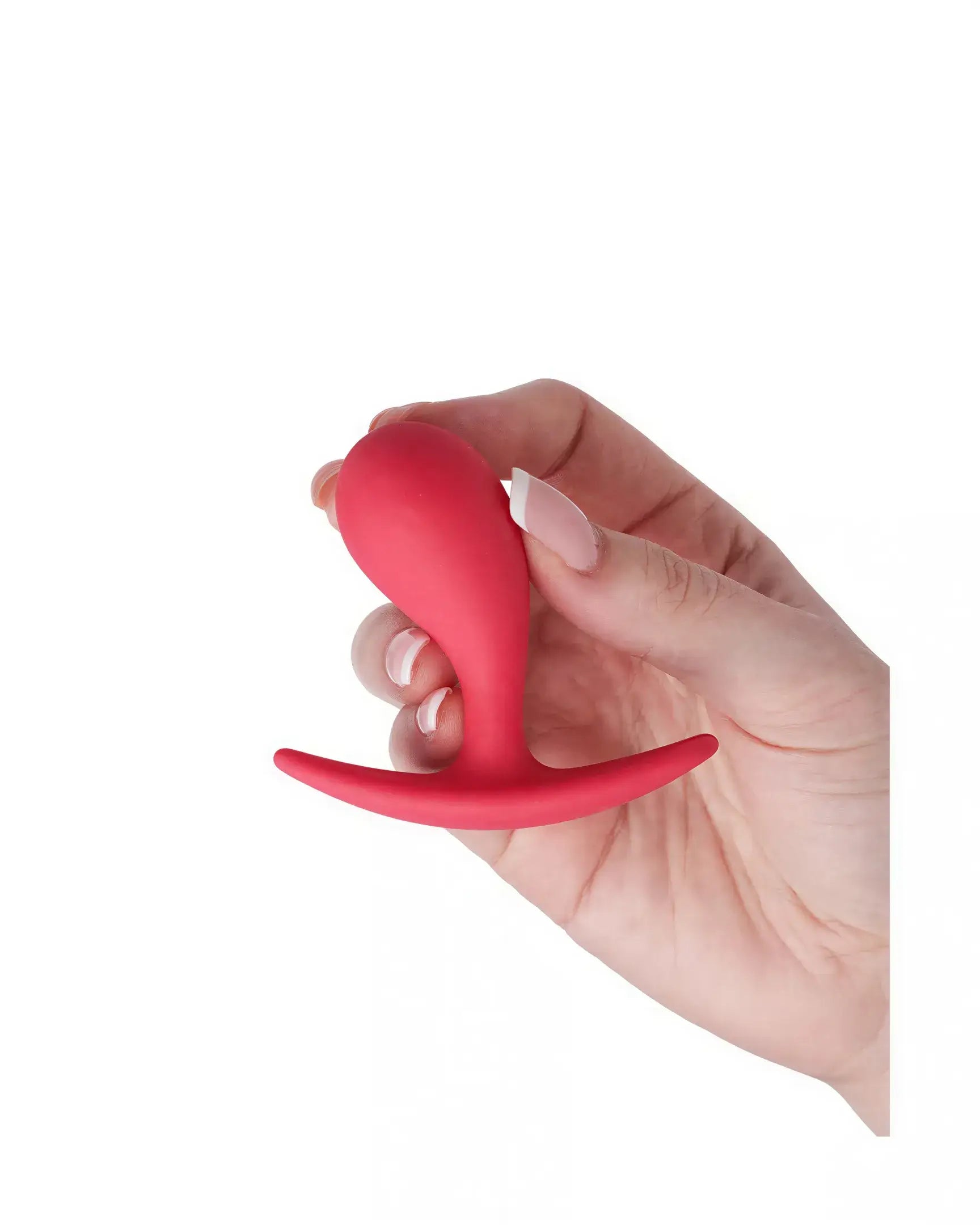 Medium curved plug in red silicone, held in a hand, showcasing its ergonomic design and smooth surface.