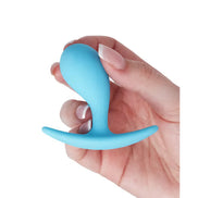 Medium curved plug in blue silicone held in a hand, featuring a tapered design and flared base for safety.